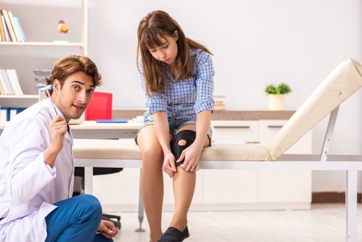 Male doctor checking with sensory hammer
