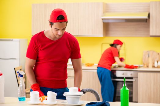 Cleaning professional contractors working at kitchen