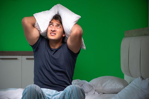Young handsome man suffering from insomnia at home