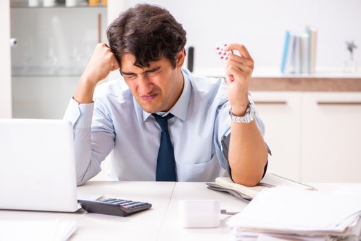 Man under stress measuring his blood pressure