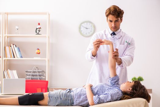 Male doctor checking joint flexibility with goniometer  