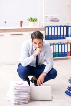 Extremely busy employee working in the office