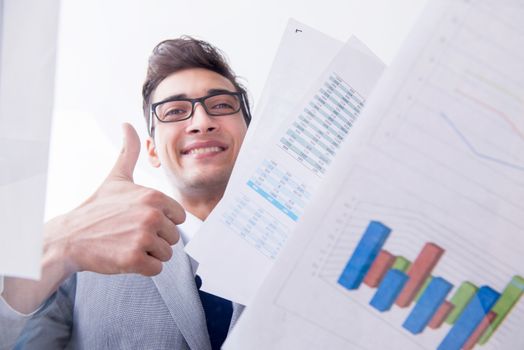 Businessman looking at financial charts and graphs