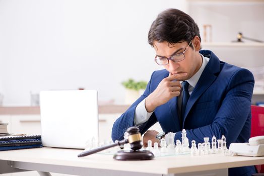 Young lawyer playing chess to train his court strategy and tactics