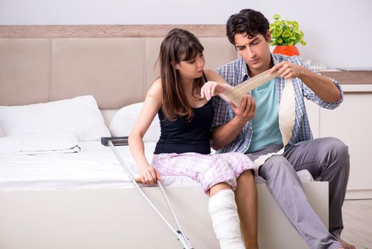Caring husband looking after his injured wife