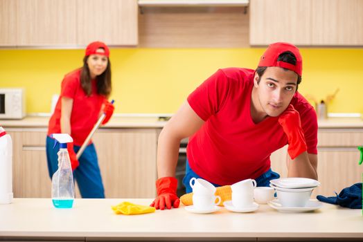 Cleaning professional contractors working at kitchen