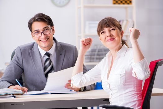 Man and woman discussing in office