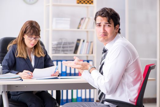 Man and woman discussing in office