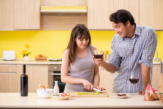 Young couple celebrating wedding anniversary at kitchen 