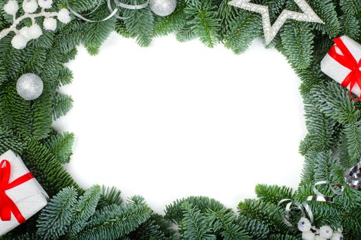 Christmas design boder frame greeting card of noble fir tree branches gift and silver baubles isolated on white background copy spcae for text card