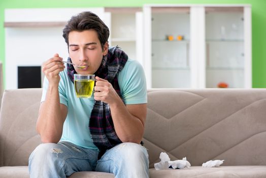 Young handsome man suffering from illness at home 