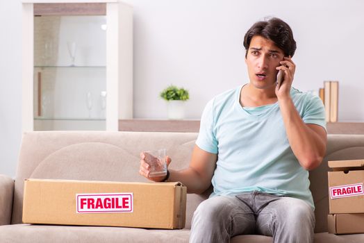 Man opening fragile parcel ordered from internet