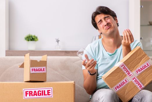 Man opening fragile parcel ordered from internet