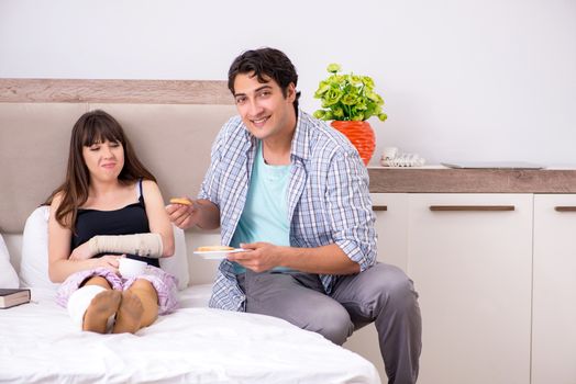 Caring husband looking after his injured wife