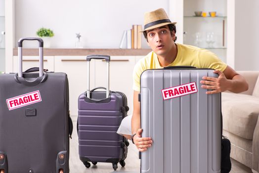 Man going on vacation with fragile suitcases