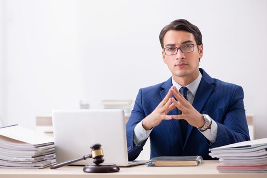 Young handsome judge working in court