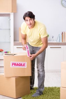 Man moving house and relocating with fragile items