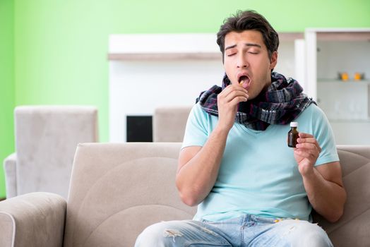 Young handsome man suffering from illness at home 