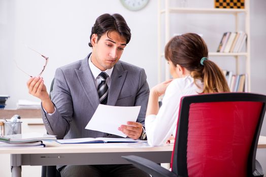 Man and woman discussing in office