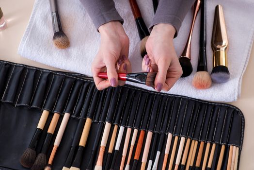 Make-up artist preparing brushes for work