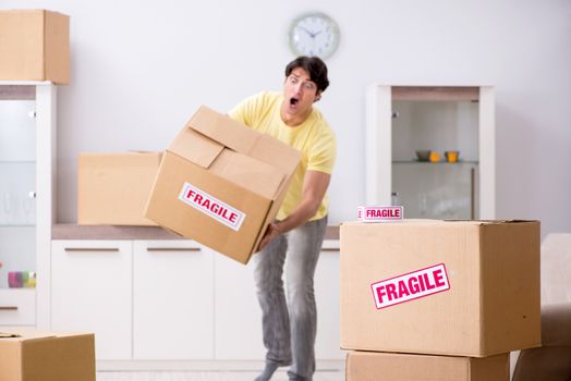 Man moving house and relocating with fragile items