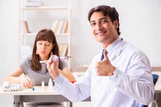 Young woman visiting male doctor ophthalmologist in hospital