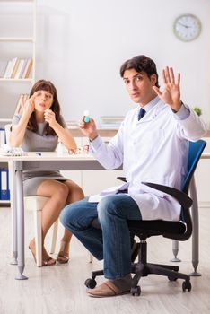 Young woman visiting male doctor ophthalmologist in hospital