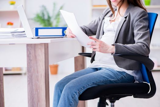 Pregnant woman struggling with pain in office