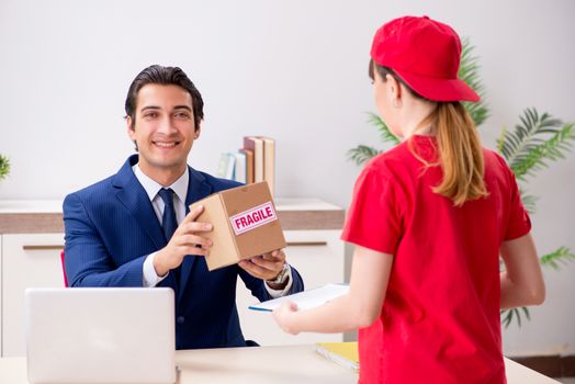 Courier delivering parcel to the office