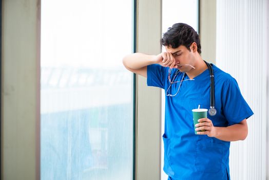 Young handsome doctor working in the hospital 