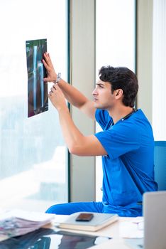 Young handsome doctor working in the hospital 