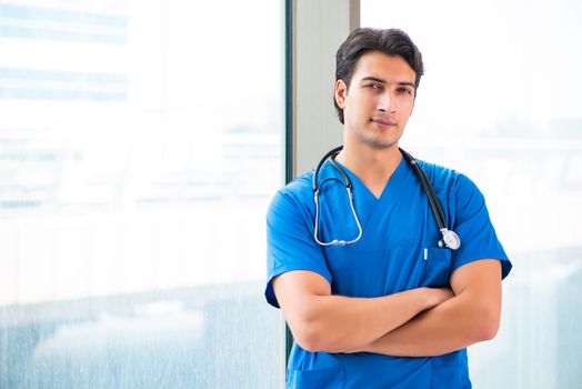 Young handsome doctor working in the hospital 