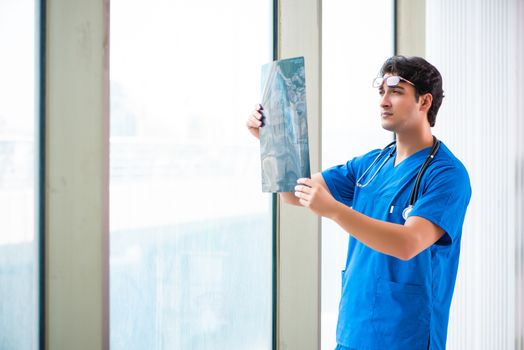 Young handsome doctor working in the hospital 