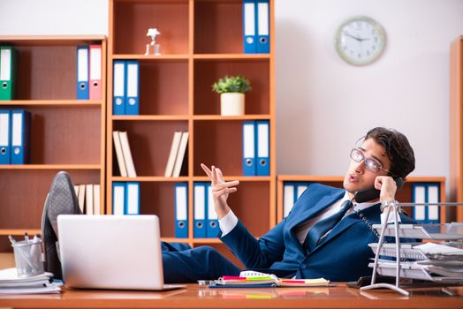 Young handsome businessman working in the office