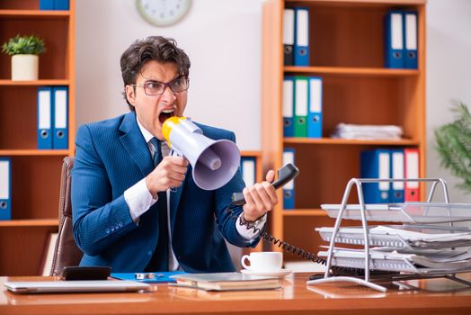 Young handsome businessman working in the office