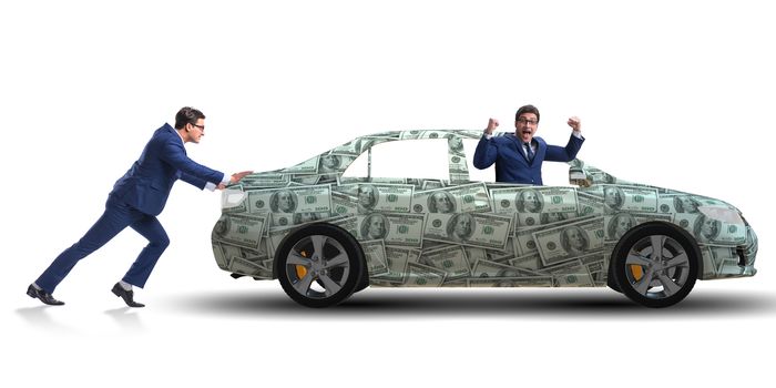 Businessman pushing car in business concept