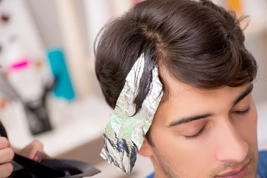 Young attracrive man visiting female barber 