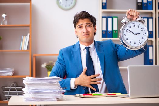 Young handsome businessman working in the office 