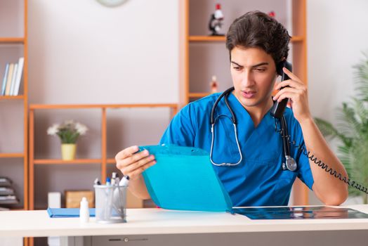 Young handsome doctor radiologyst working in clinic 