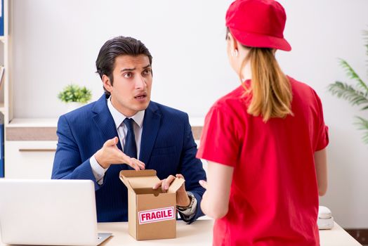 Courier delivering parcel to the office