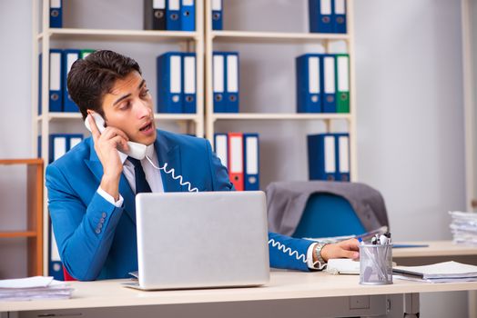 Young handsome businessman working in the office 