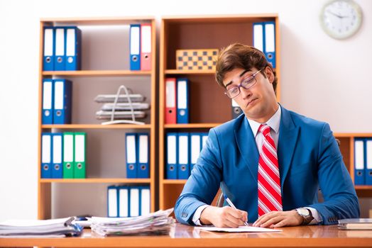 Young handsome politician sitting in office 