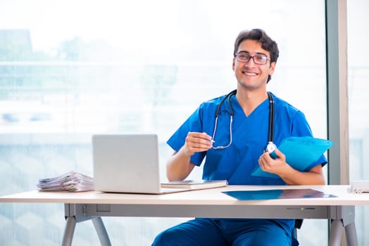 Young handsome doctor working in the hospital 