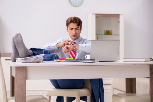 Young attractive businessman working in the office  