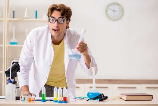 Funny crazy chemist doing experiments and tests