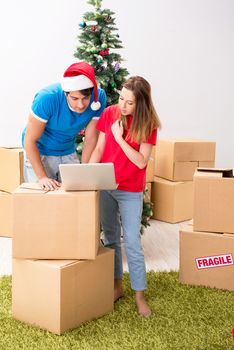 Young family celebrating christmas in new home