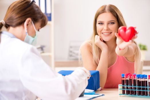 Young beautiful woman during blood test sampling procedure  