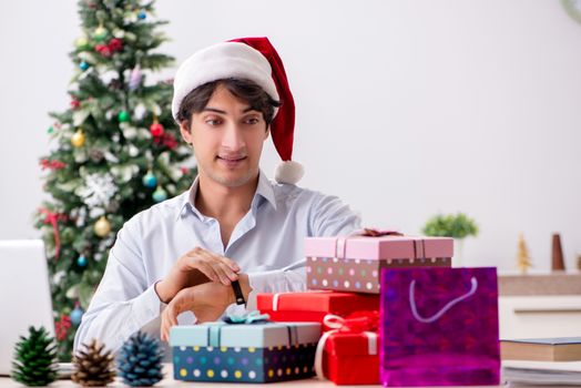 Young employee businessman in office christmas concept