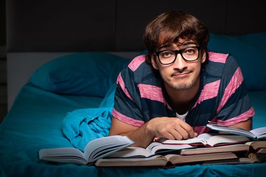 Young student preparing for exams at night at home 