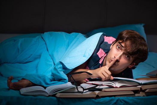 Young student preparing for exams at night at home 